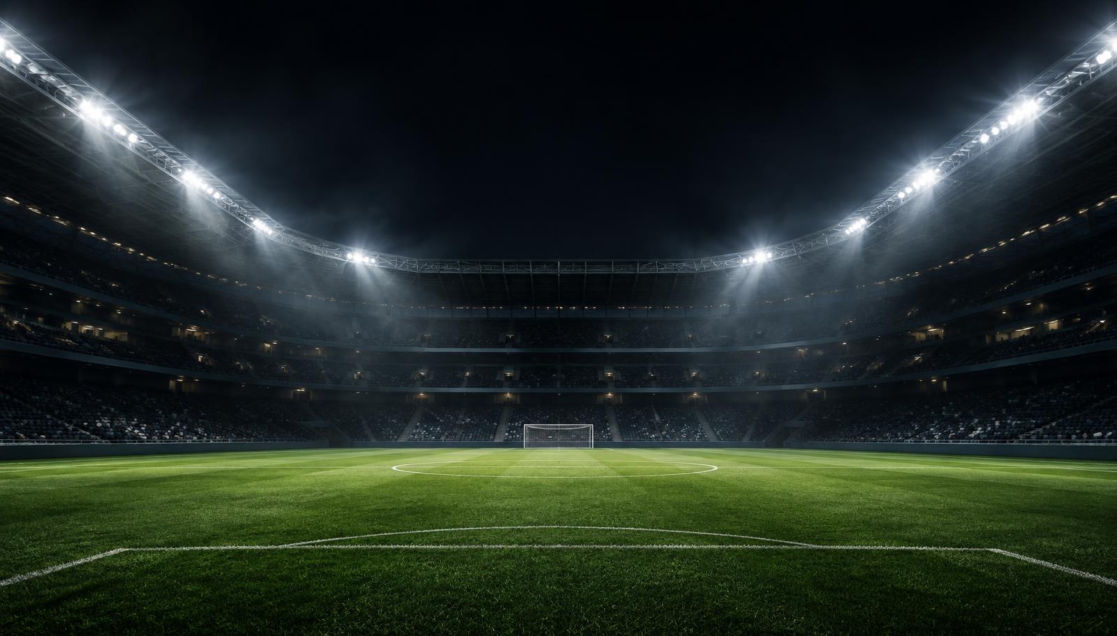 Floodlit football stadium at night